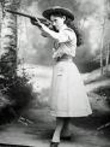 Annie teaches self how to use a rifle