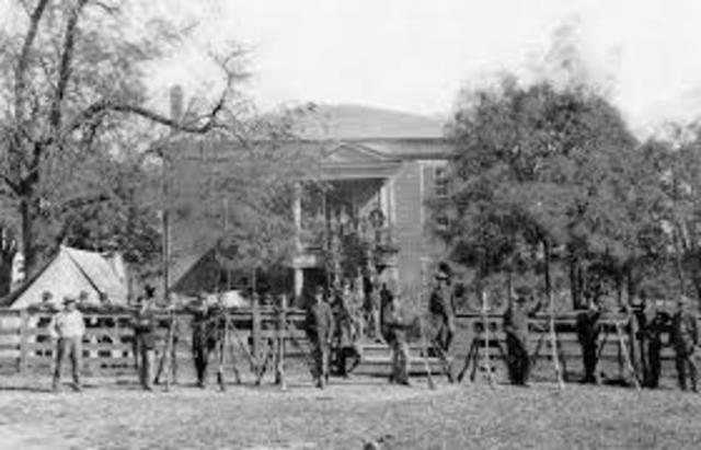 General Robert E. Lee surrenders his Confederate Army to General Ulysses S. Grant at the village of Appomattox Court House in Virginia