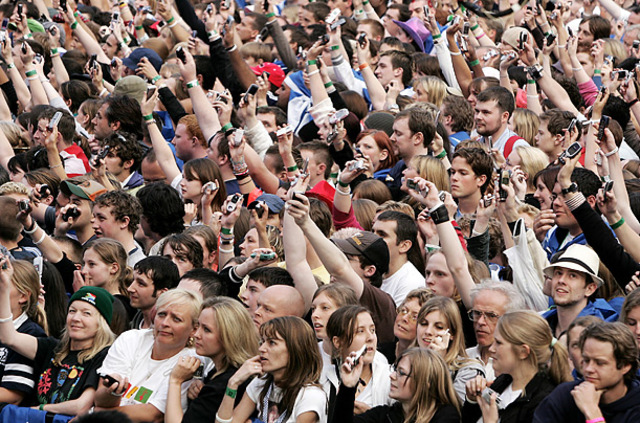 MultiplicityFans at a Live 8 concert in Edinburgh brandish their phones.