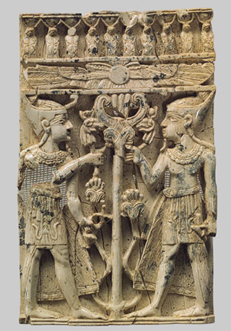 Egyptianizing figures on either side of a tree with a winged disk