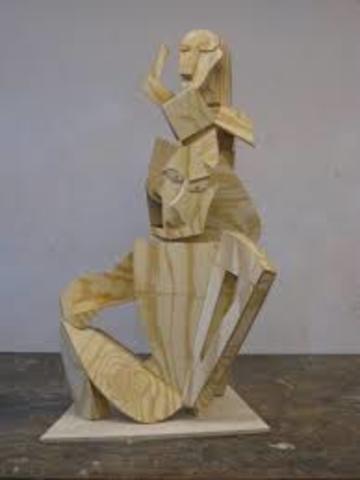 Begins carving wooden sculptures