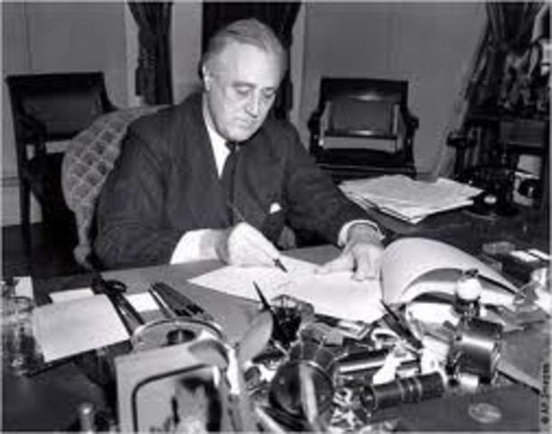 President Roosevelt signs Lend-Lease Act