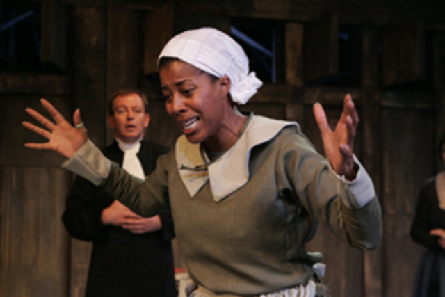 He makes Tituba confess to being with the Devil