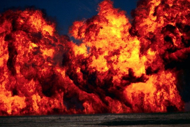 Montag takes a book from a house he burns