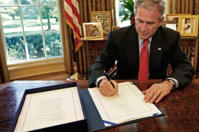 Bush signs the Emergency Economic Stabilization Act
