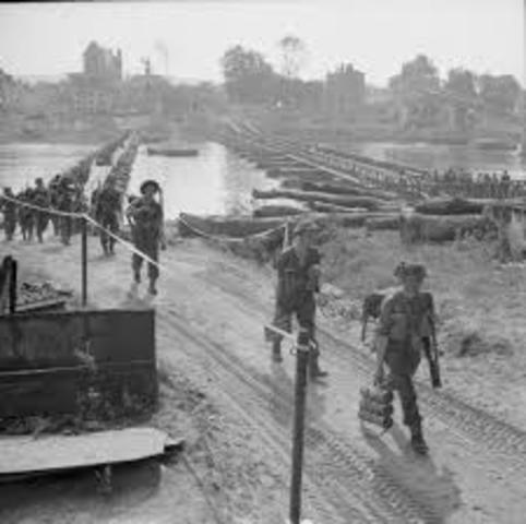 US troops cross the Rhine River at Remagen.