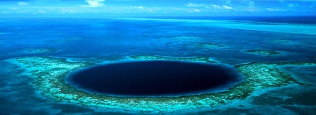 Wide angle view Great Blue Hole in Belize courtesy a Private Island.