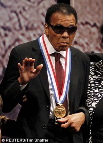 Ali lights Olympic torch