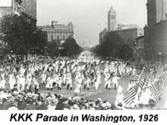 Ku Klux Klan members stage a major march through Washington, D.C. Scopes trial takes place in Dayton, Tennessee.