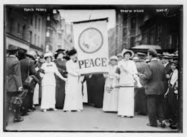 Suffregists, dressed in black and carrying a banner of a dove, marched down New York City's Fifth Avenue.
