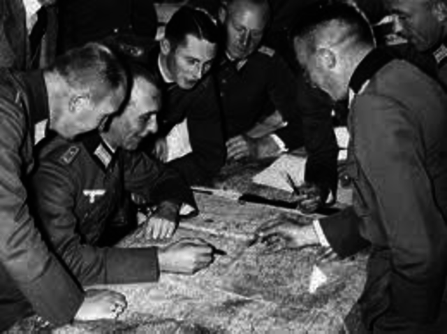 Hitler openly announces to his cabinet he will defy the Treaty of Versailles