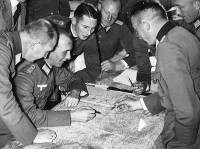 Hitler announces to his cabinet he will defy the Treaty of Versailles