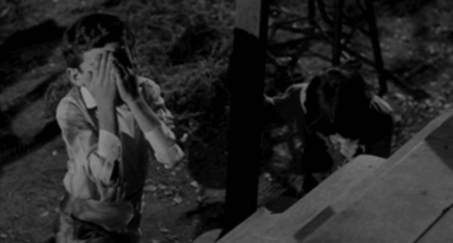 Scout, Dill, and Jem peek into the Radley's place