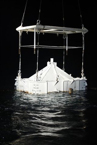 Crews lower 100-ton box over the blown-out well