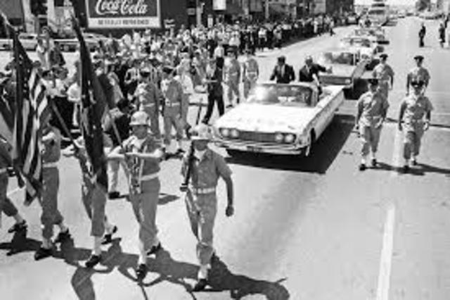 motorcade through Dealey Plaza in downtown Dallas