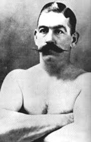 John Sullivan holds "heavyweight title"