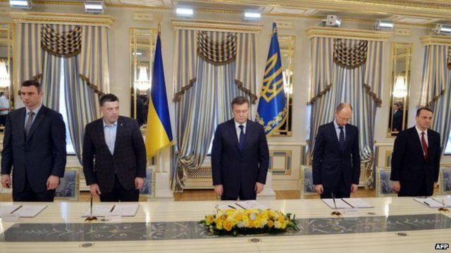 Yanukovych signs compromise deal with opposition leaders.