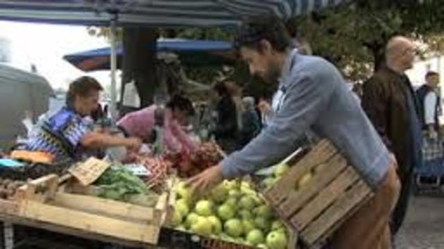 Bruno und Müller entladen Apfel, sie erhalten ein Tüte Äpfel für ihre Arbeit.