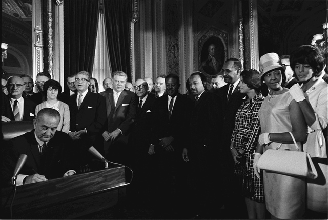 President Johnson signs the Civil Rights Act