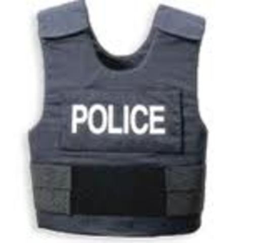 Police start wearing soft body armor to protect themselves against handgun assaults.