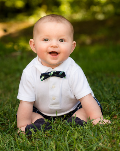 8 Months - Pulls strings to get object, sits well without support