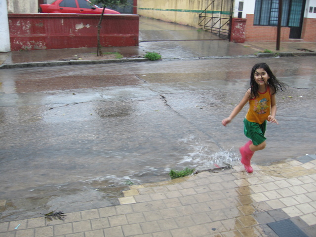 Playing in the rain in font of my house