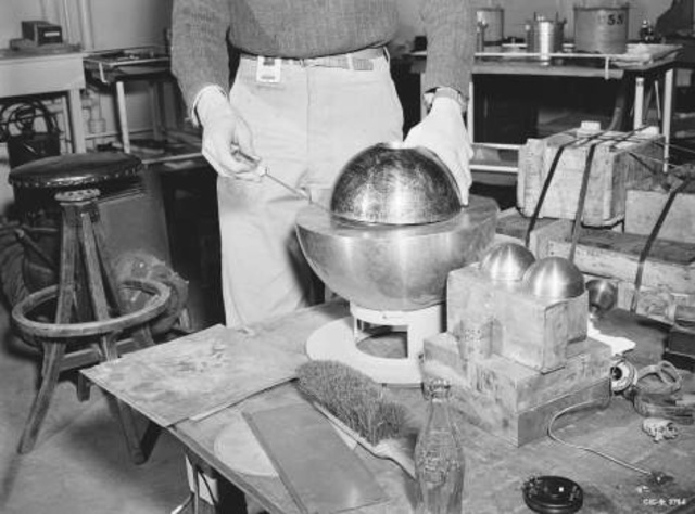 At the bottom of Los Alamos Canyon, scientist Louis Slotin assembles, for the first time, two full-scale plutonium hemispheres in a test for criticality.