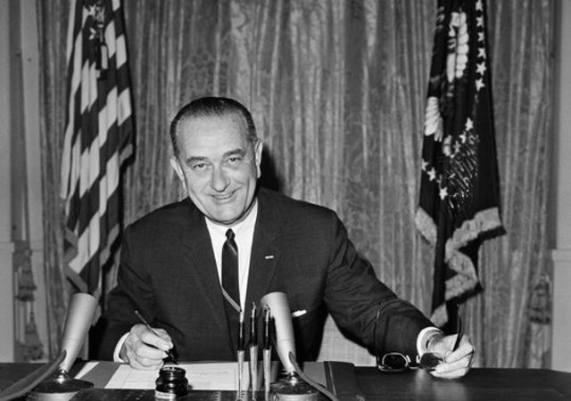 President Johnson signs the Resolution