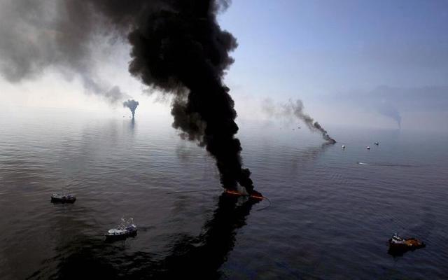 Smoke billows from a controlled burn of spilled oil off the Louisiana coast in the Gulf of Mexico coastline