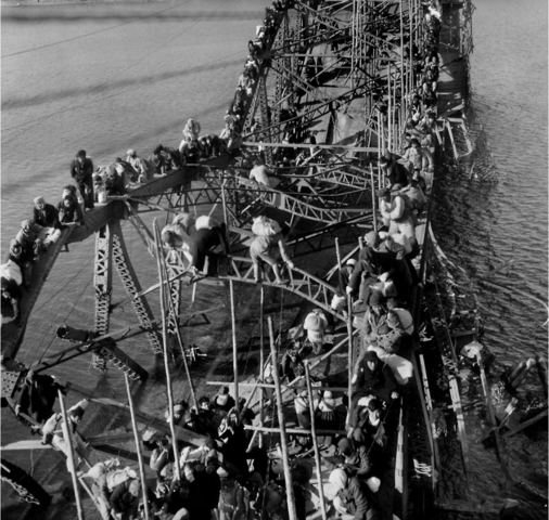 Flight of refugees across wrecked bridge