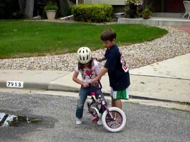 teaching my sister how to ride bike.