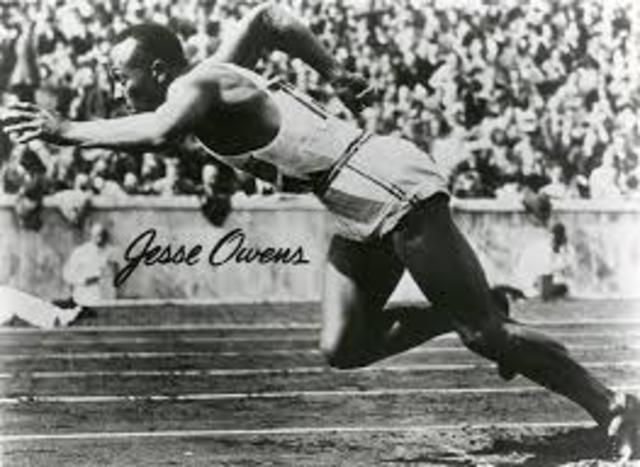 Jesse Owens wins four gold medals at Olympics in Germany