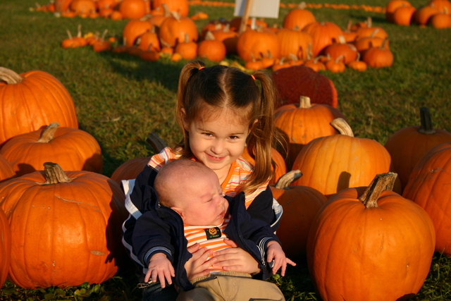 At pumpkin patch with newborn brother