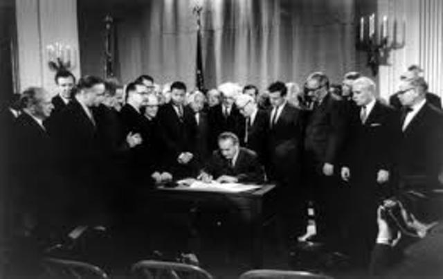 President Johnson signs the resolution