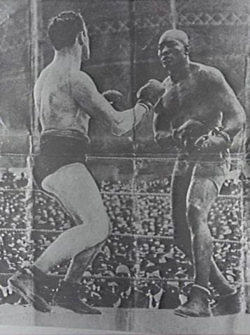 Jack Johnson beats Tommy Burns