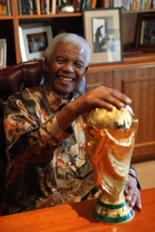 Mandela gets presented with the FIFA world cup trophy