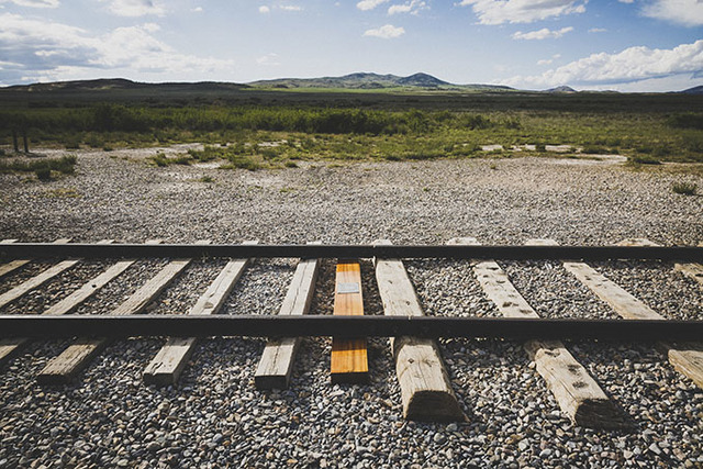 A golden spike is driven into a railroad tie at Promontory Point, Utah