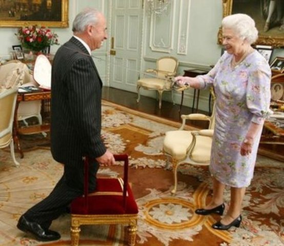 he was knighted by England’s Queen Elizabeth II. thats not really it happening but i couldnt find an actual picture of it.