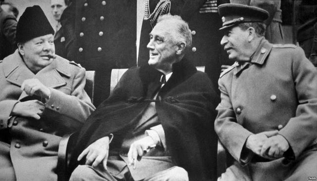 Winston Churchill, Franklin Roosevelt, and Joseph Stalin meet at Yalta to discuss post-war Europe