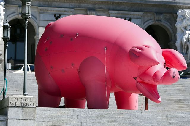 Gene Stilp displays an inflatable pig in protest of the pay raise