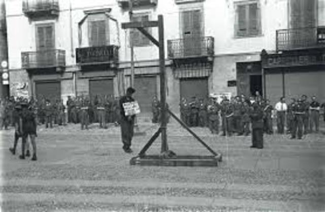 Mussolini is hanged by Italian partisans