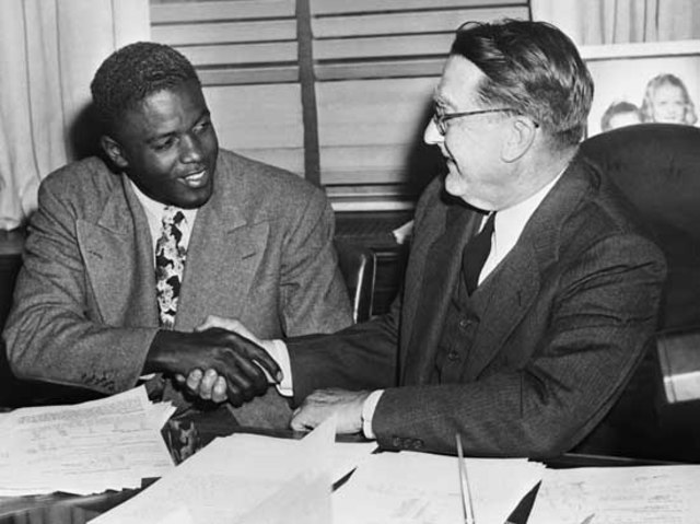 Jackie Robinson signs an MLB contract