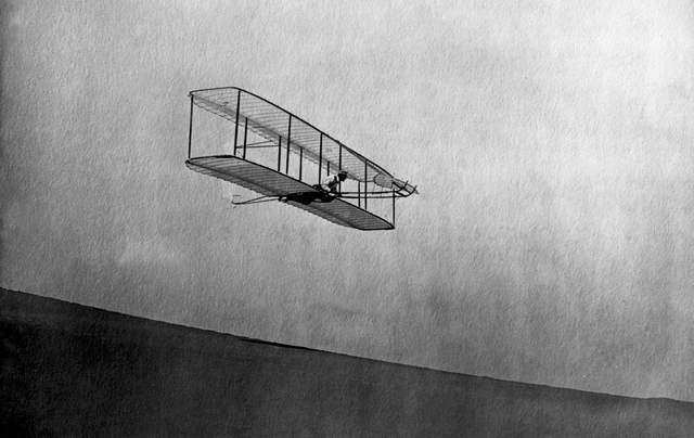 The Wright brothers make their first powered flight in the Wright Flyer.