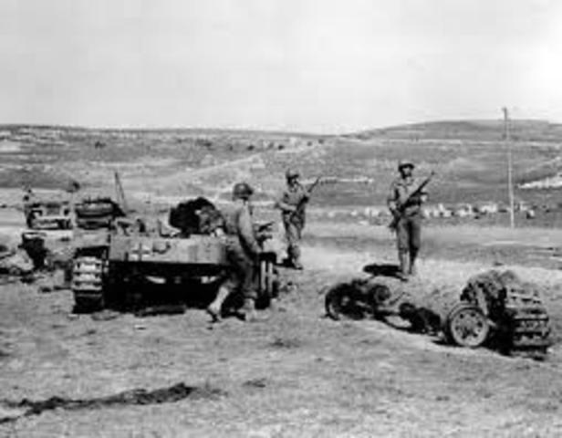 Germans begin a withdrawal from Tunisia, Africa.