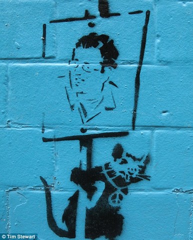 Stewart. Reported Self-Portrait of Banksy on a Blue Wall.