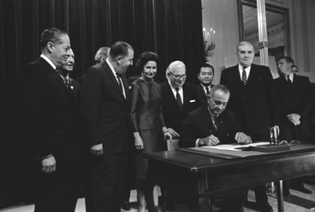 President Johnson signs the Civil Rights Act.