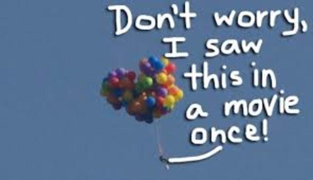 Man using Balloons to Fly