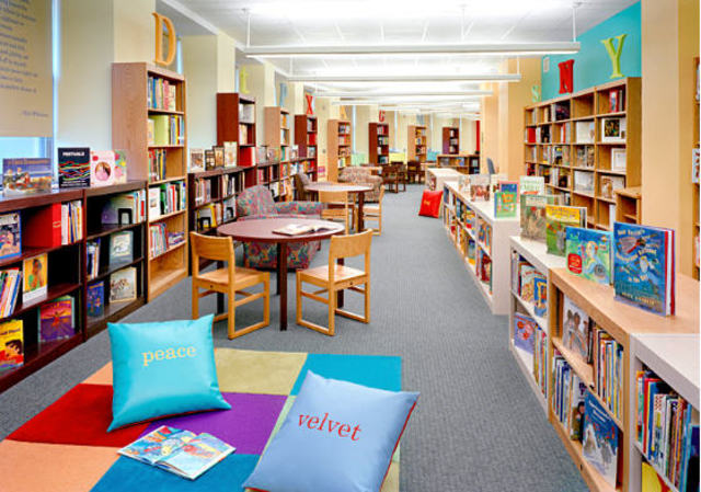 Irene sets up a library with jigsaw puzzles, games, dolls, musical instruments and books for the children.