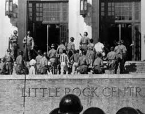 Federal troops enforce integration in Little Rock, Arkansas as the Little Rock 9 enroll at Central High School.