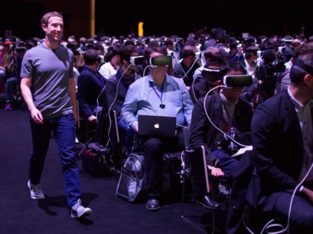 Here is a picture of Mark Zuckerberg walking through a room of people with VR headsets on